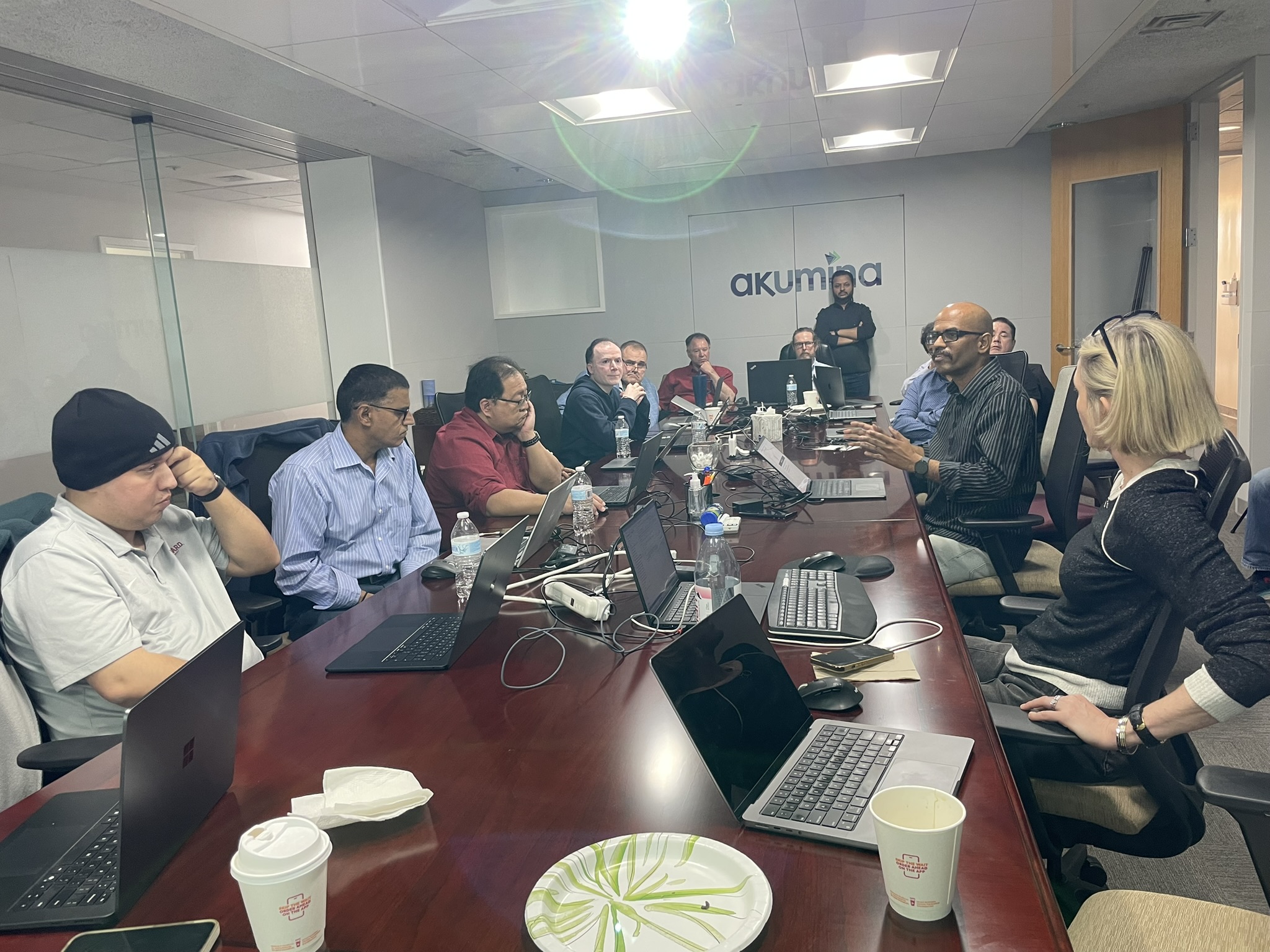 Small group discussion at the Akumina conference room during the April 2026 workshop